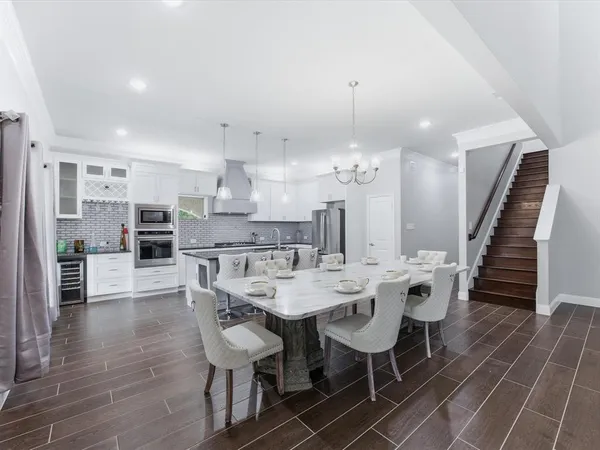 a kitchen with stainless steel appliances kitchen island granite countertop a stove a sink and a refrigerator