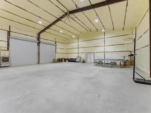 an aerial view of a house with a yard and lake view