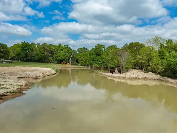 a view of a lake with a house in the background