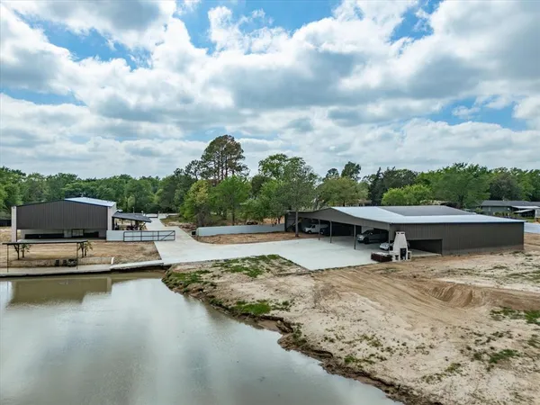 an aerial view of a houses with a lake view