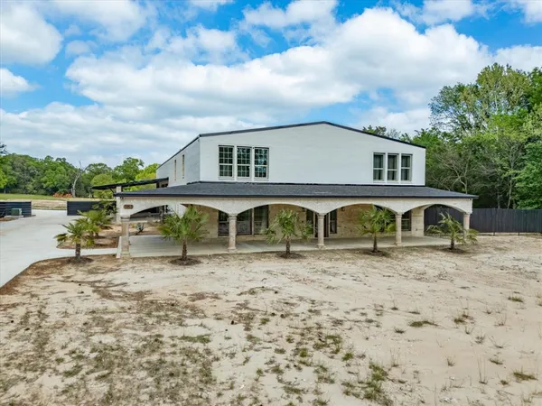 a view of a yard with wooden fence