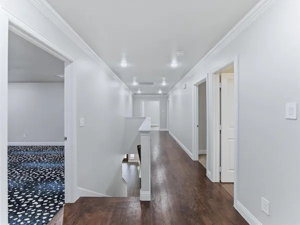 a view of hallway with wooden floor