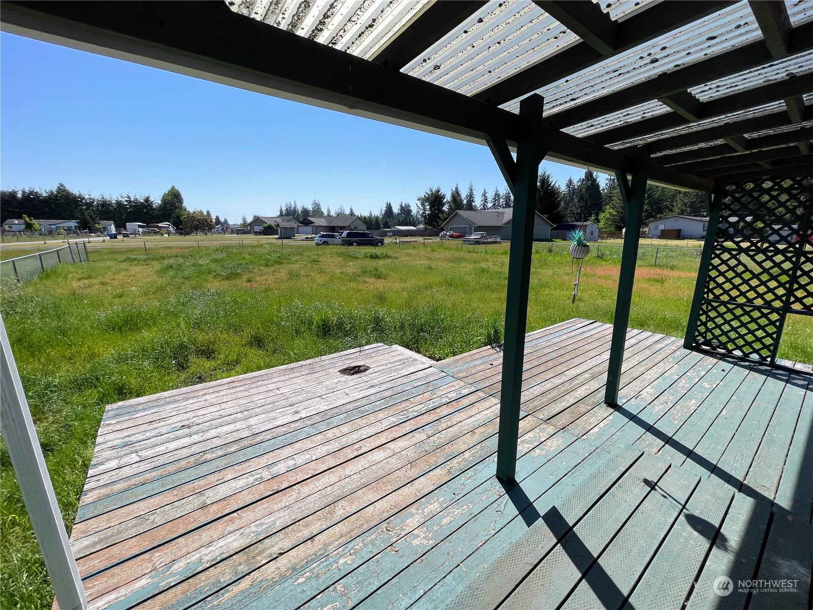 17902 Michelles Lane Southwest Rochester, WA 98579 - Photo 21 of 25 a view of a patio with dining table and chairs with wooden floor