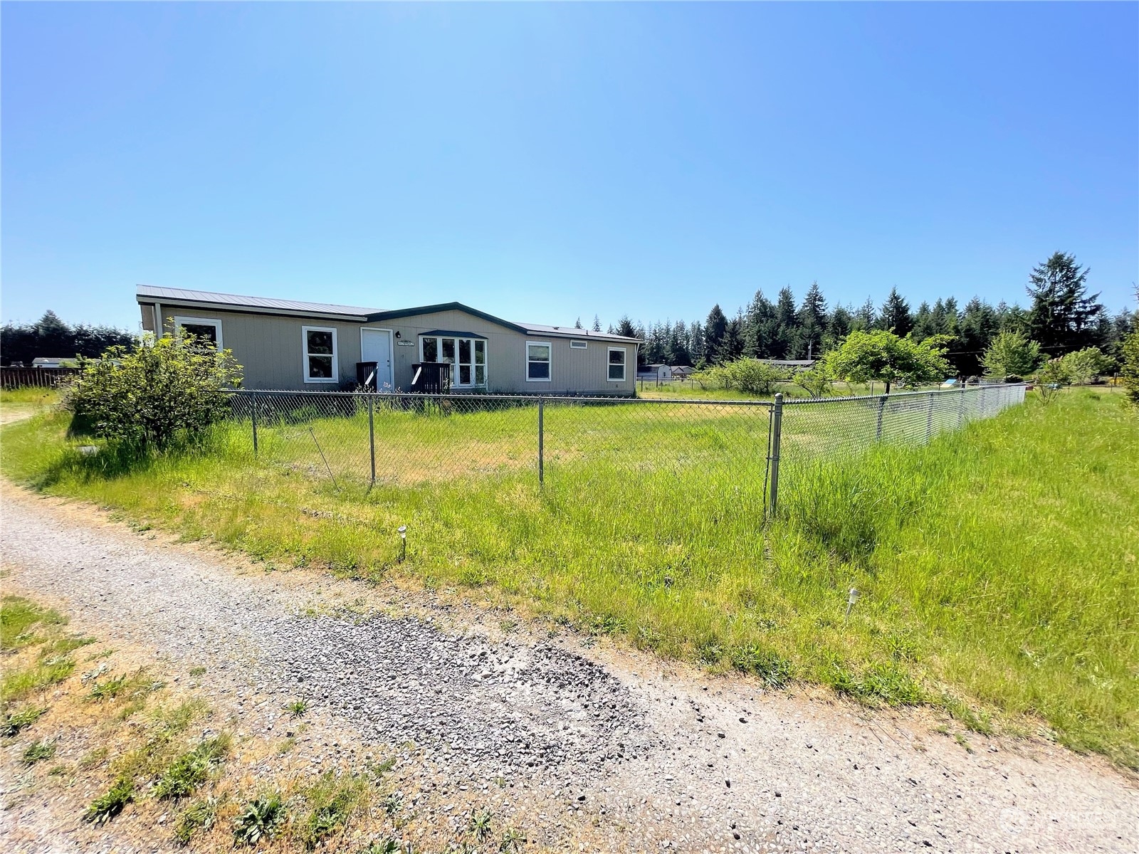17902 Michelles Lane Southwest Rochester, WA 98579 - Photo 4 of 25 a view of a house with a yard and a large tree