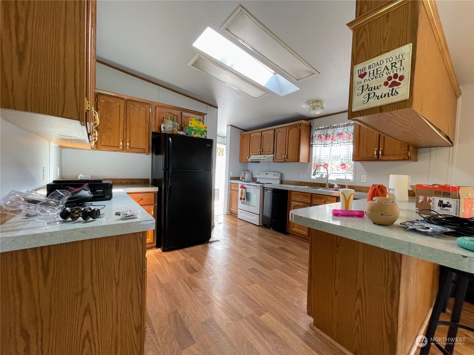 17902 Michelles Lane Southwest Rochester, WA 98579 - Photo 7 of 25 a kitchen with stainless steel appliances granite countertop a refrigerator a sink dishwasher and wooden cabinets with wooden floor