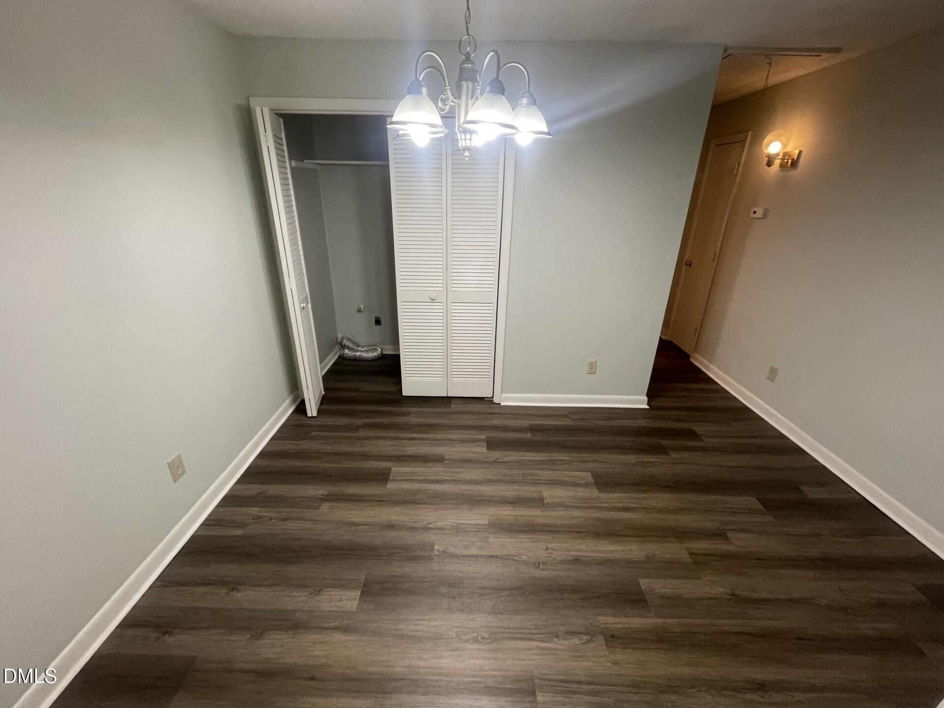 5155 Windy Hill Drive, Unit 202 Raleigh, NC 27609 - Photo 4 of 10 a view of a hallway with wooden floor and staircase