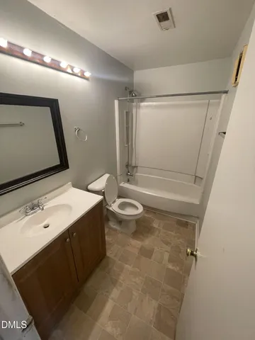 a bathroom with a sink a toilet a mirror and shower