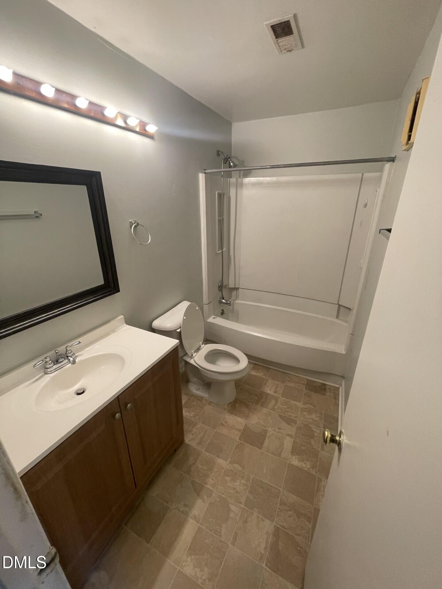 5155 Windy Hill Drive, Unit 202 Raleigh, NC 27609 - Photo 8 of 10 a bathroom with a sink a toilet a mirror and shower