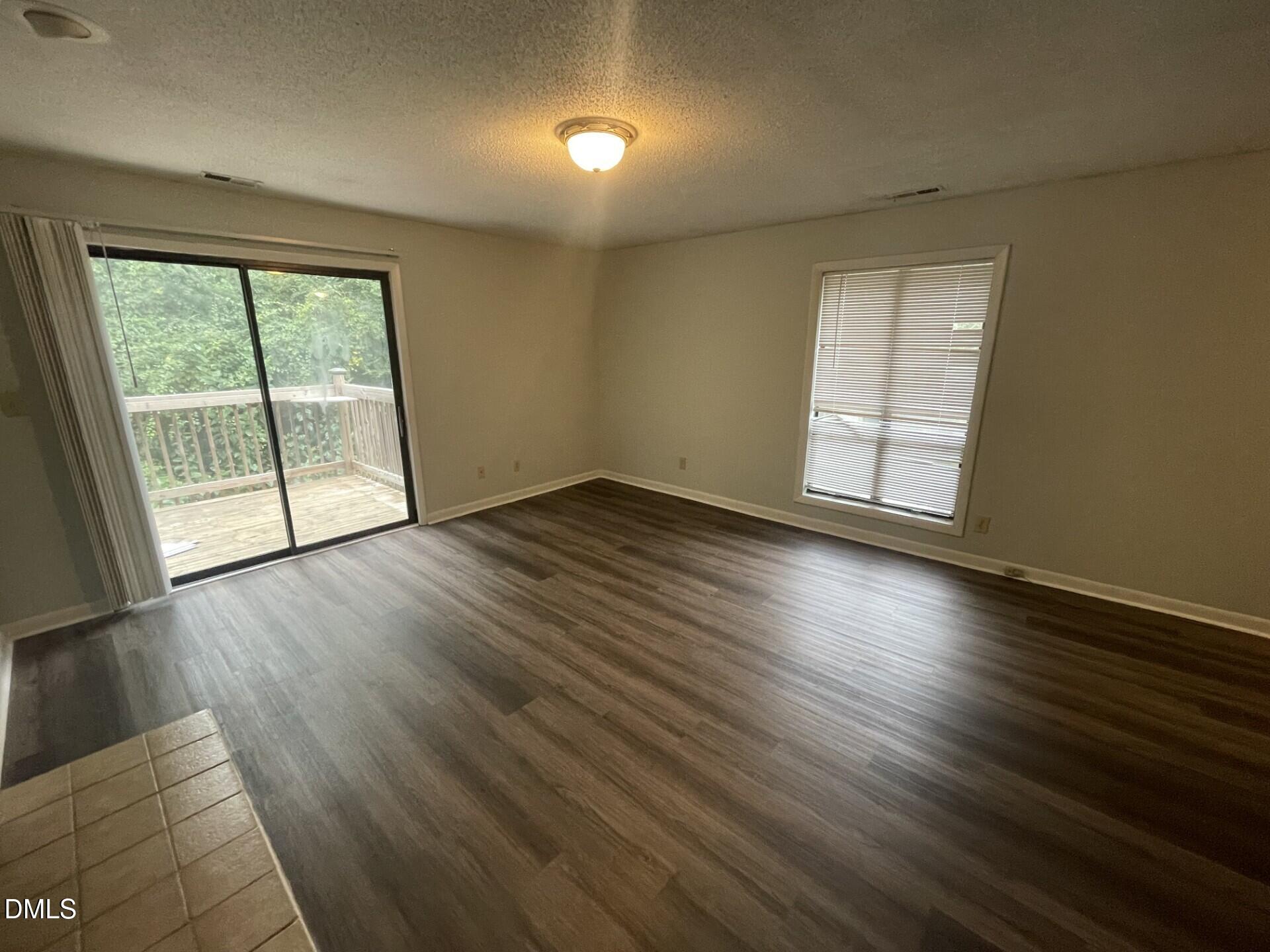 5155 Windy Hill Drive, Unit 202 Raleigh, NC 27609 - Photo 9 of 10 an empty room with wooden floor and windows