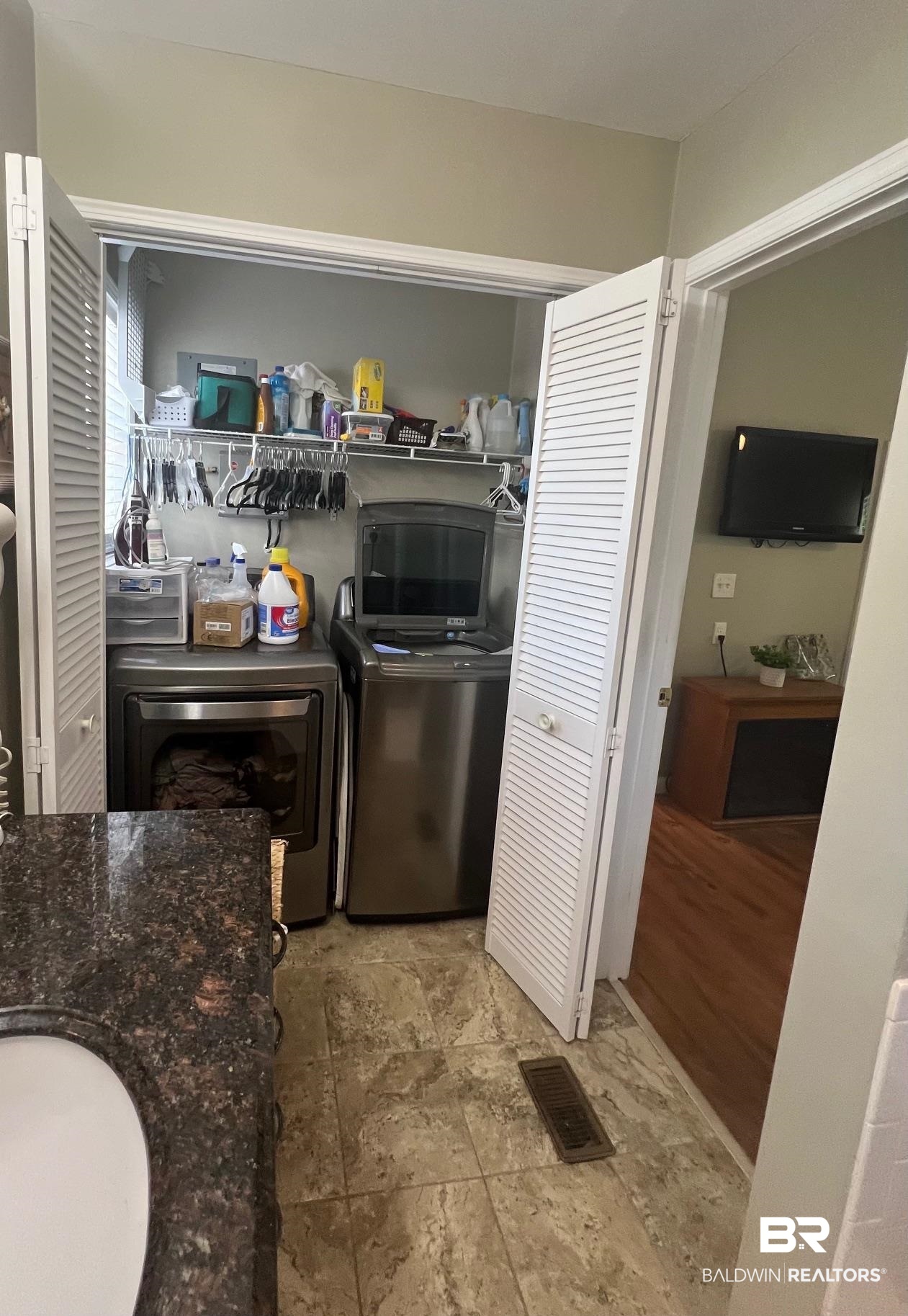 168 Defuniak Loop Lillian, AL 36549 - Photo 6 of 28 Kitchen featuring light hardwood / wood-style floors, separate washer and dryer, and dark stone countertops