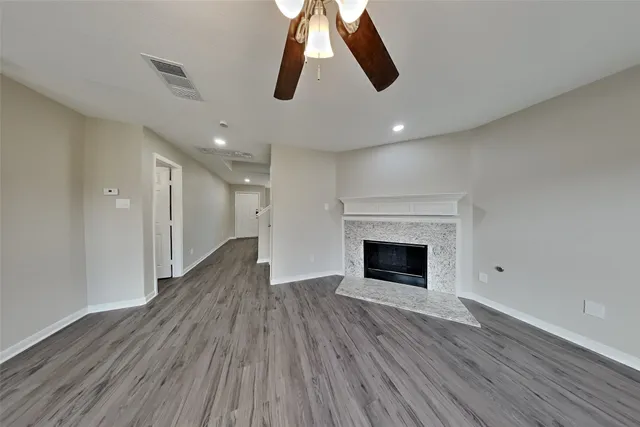 wooden floor in an empty room with a fireplace