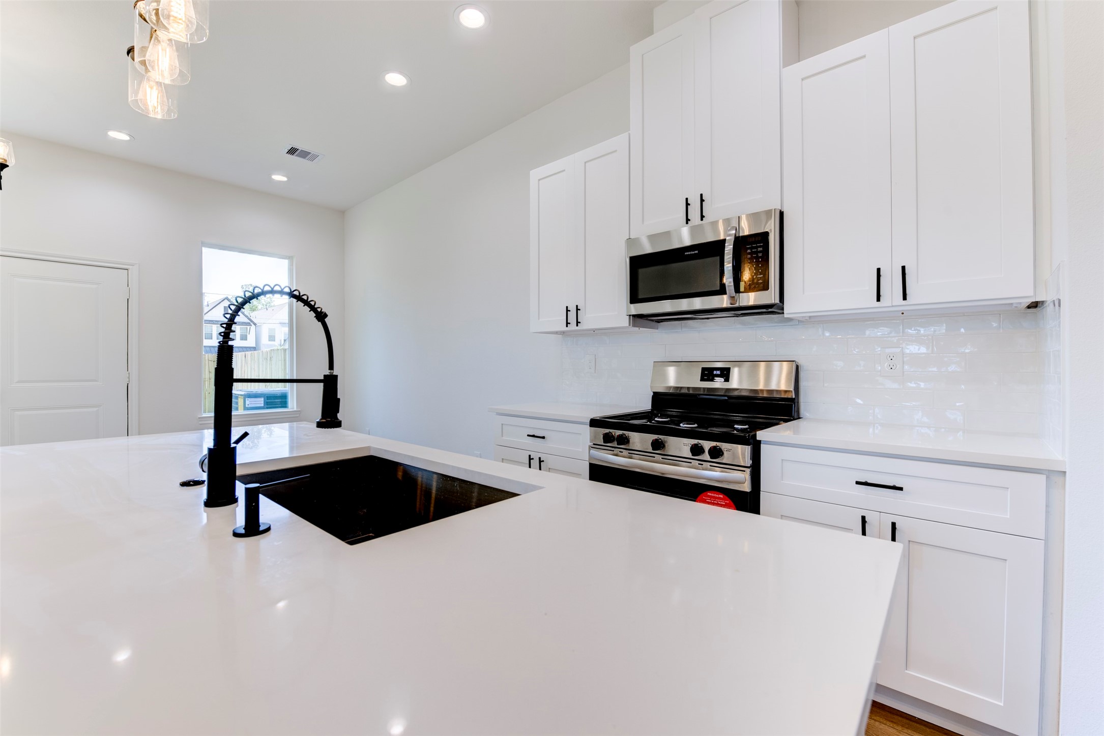 6807 Paris Street Houston, TX 77021 - Photo 11 of 37 Spacious island with deep sink and gooseneck faucet, ideal for prep and entertaining.