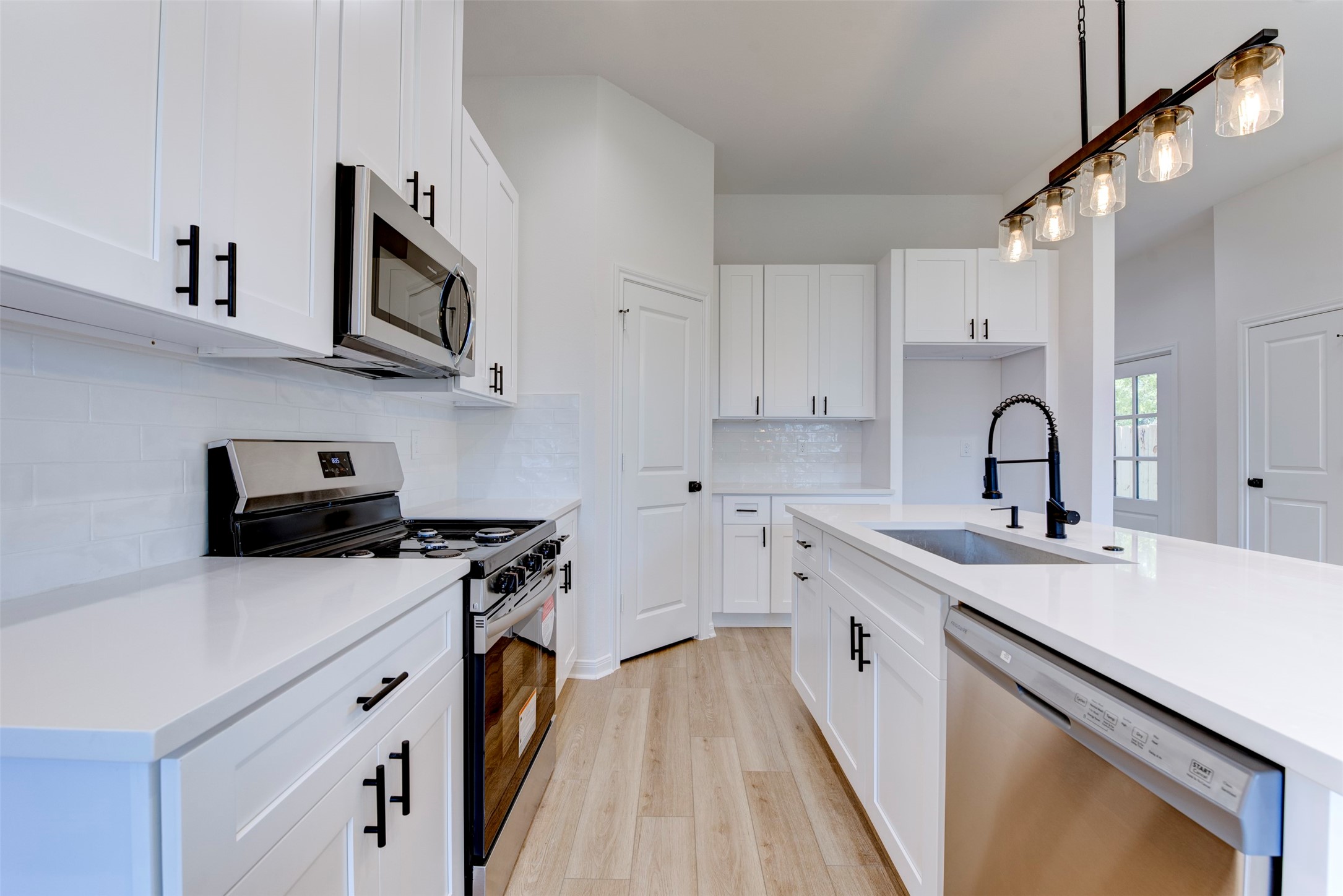 6807 Paris Street Houston, TX 77021 - Photo 9 of 37 Functional kitchen layout featuring stainless steel appliances and ample cabinet storage.