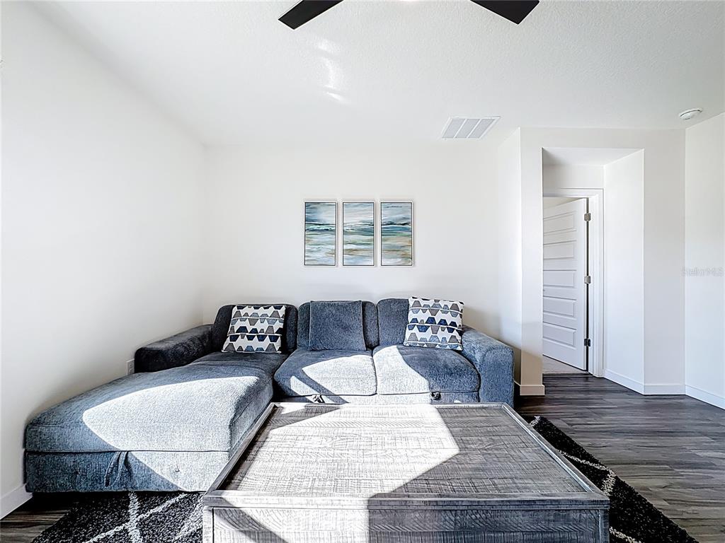 348 Talisi Loop St. Cloud, FL 34771 - Photo 15 of 35 a living room with furniture and wooden floor