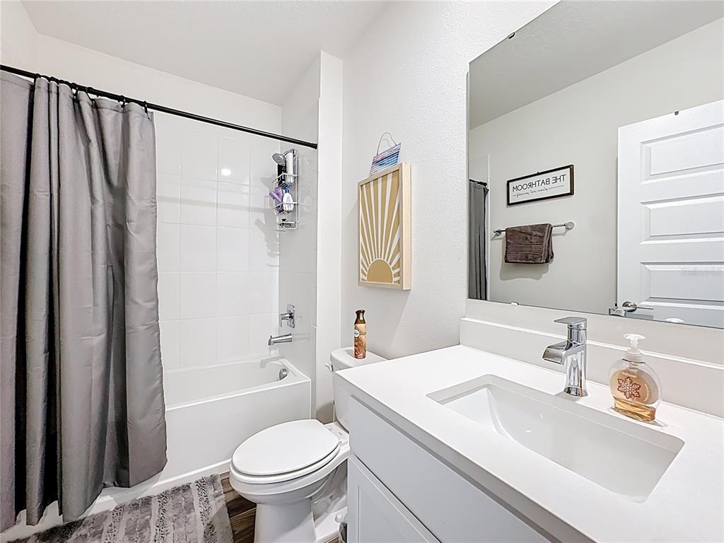 348 Talisi Loop St. Cloud, FL 34771 - Photo 19 of 35 a bathroom with a sink toilet and shower