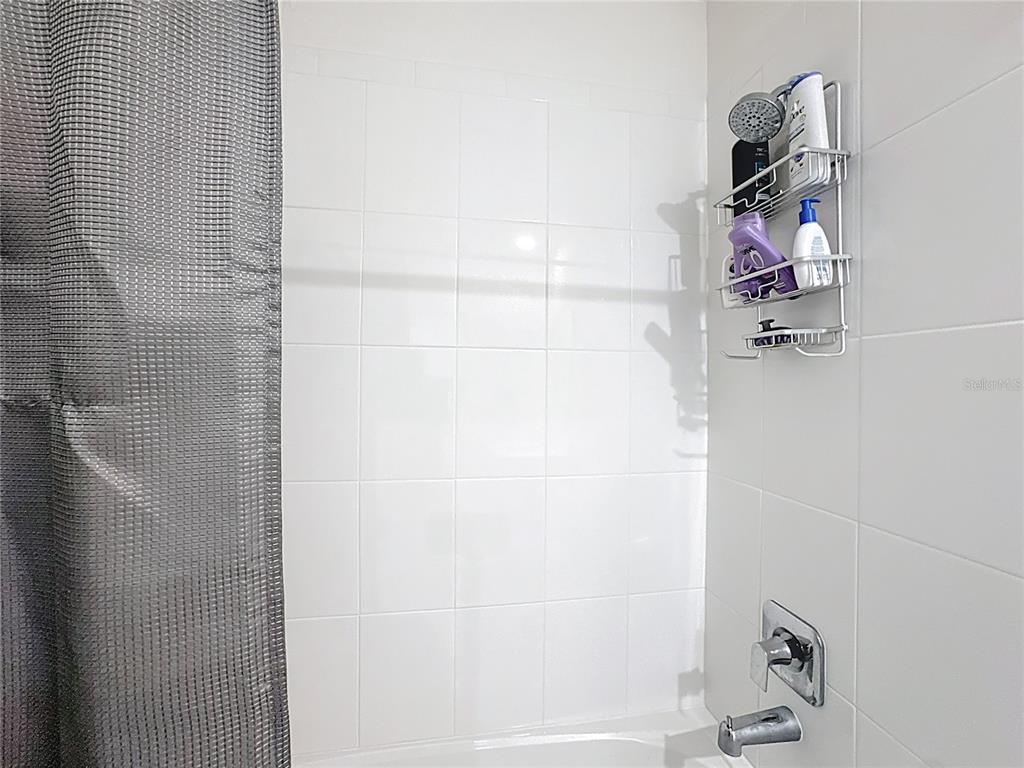 348 Talisi Loop St. Cloud, FL 34771 - Photo 20 of 35 a bathroom with a shower