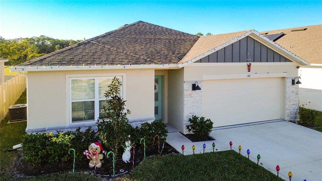 348 Talisi Loop St. Cloud, FL 34771 - Photo 2 of 35 a view of a house with a yard