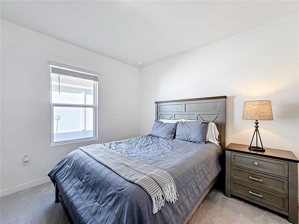 348 Talisi Loop St. Cloud, FL 34771 - Photo 21 of 35 a bedroom with a bed and a window