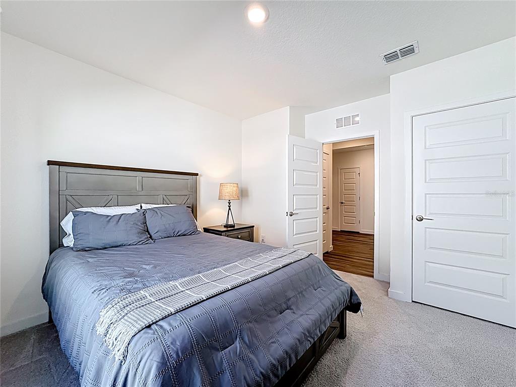 348 Talisi Loop St. Cloud, FL 34771 - Photo 22 of 35 a bedroom with a bed and closet