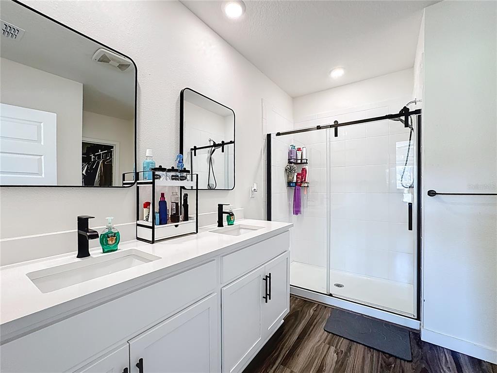 348 Talisi Loop St. Cloud, FL 34771 - Photo 26 of 35 a bathroom with a sink and a mirror