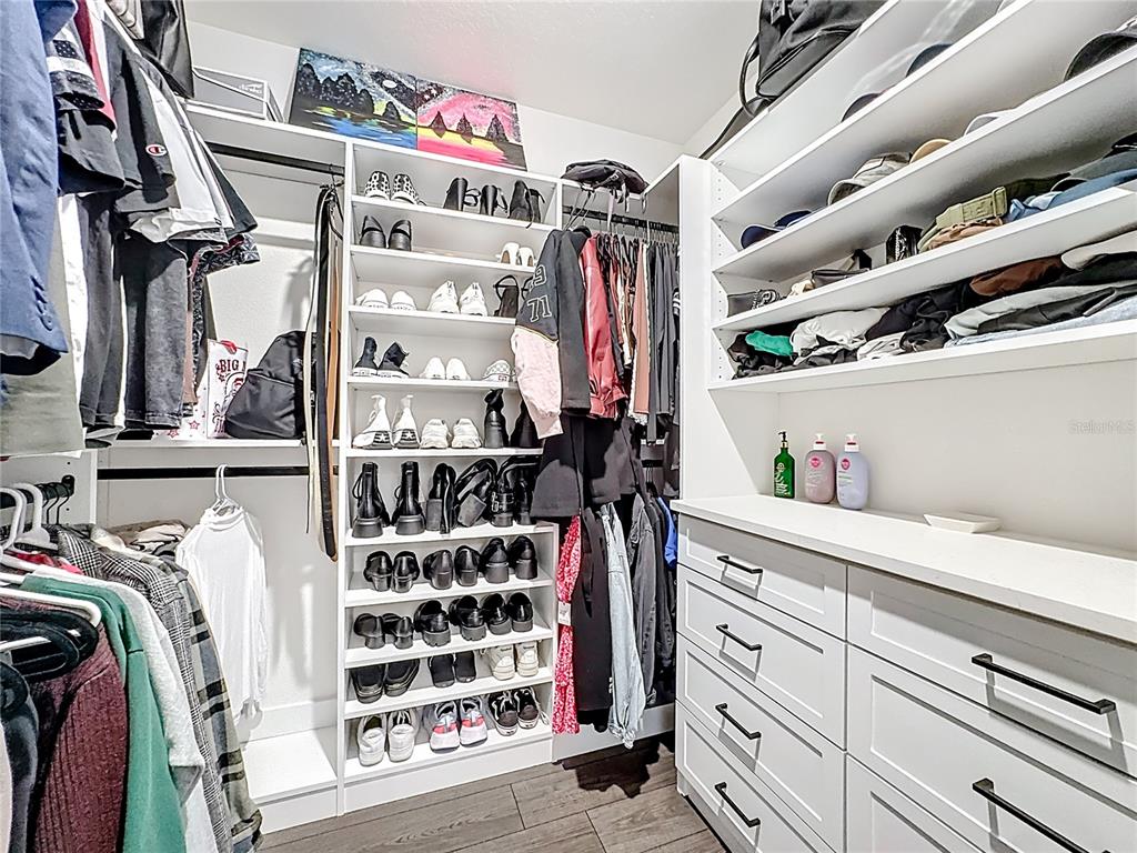 348 Talisi Loop St. Cloud, FL 34771 - Photo 30 of 35 a view of walk in closet with clothes and shoes