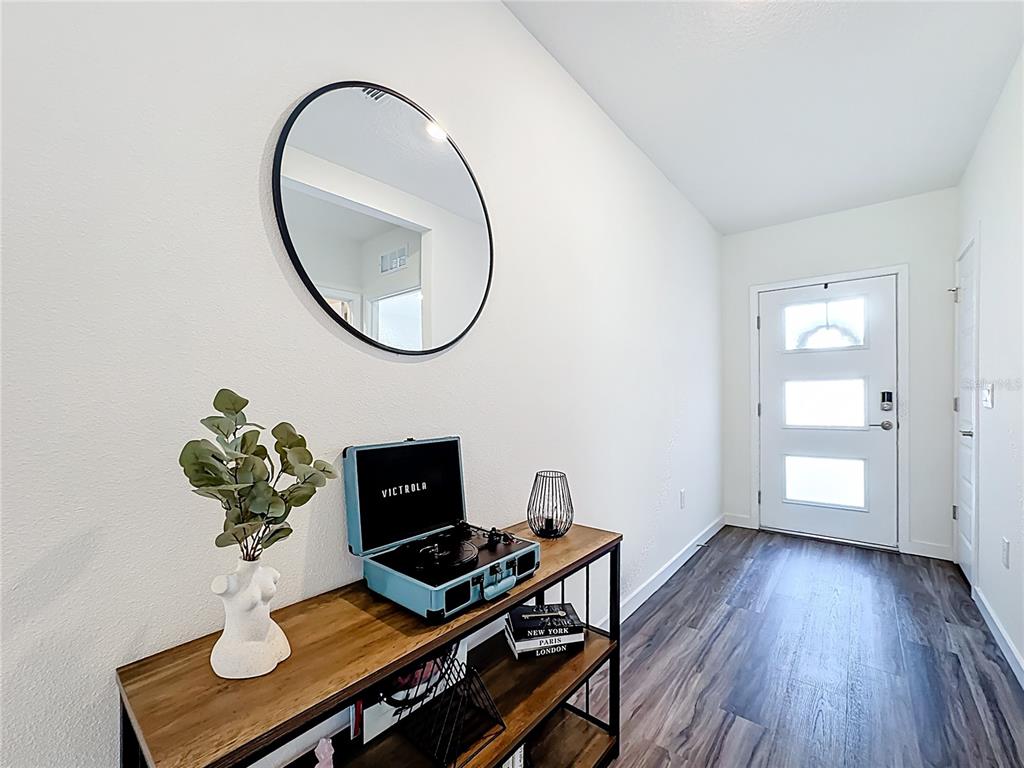 348 Talisi Loop St. Cloud, FL 34771 - Photo 5 of 35 a view of a workspace with furniture and a potted plant