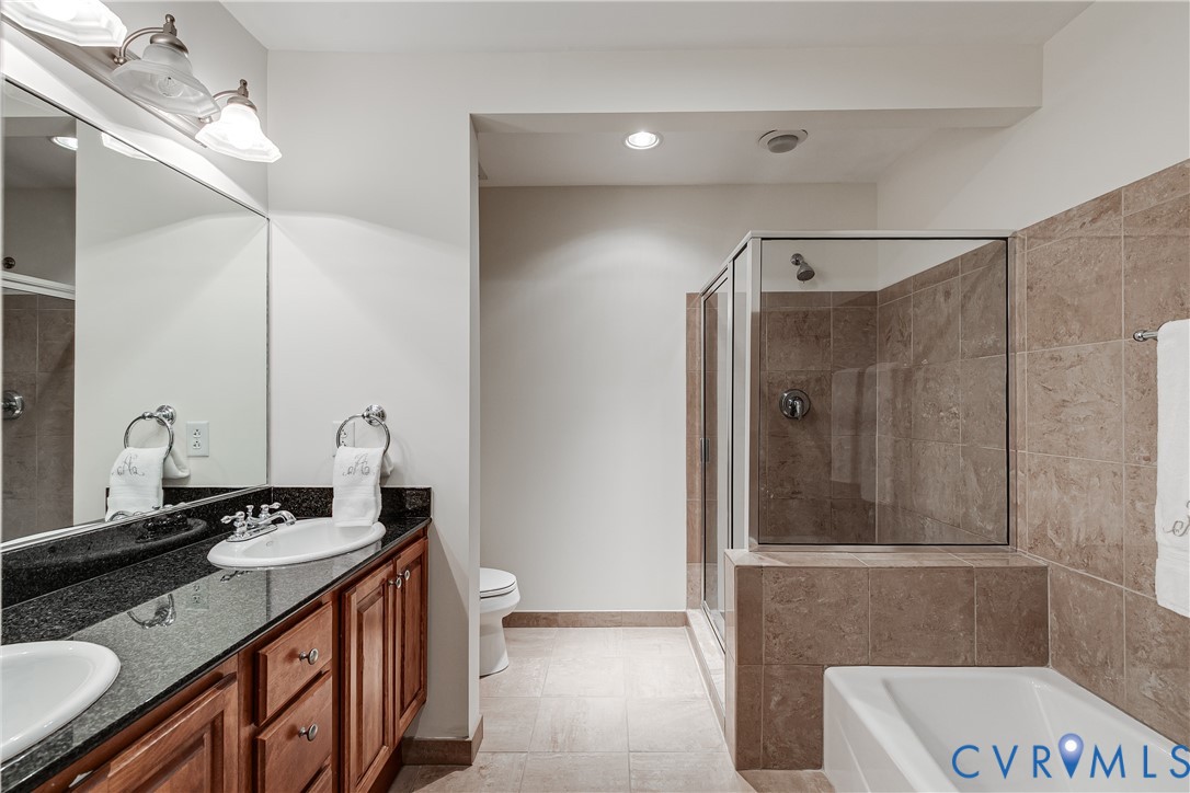 413 Stuart Circle, Unit 3D Richmond, VA 23220 - Photo 19 of 26 a bathroom with a double vanity sink and mirror