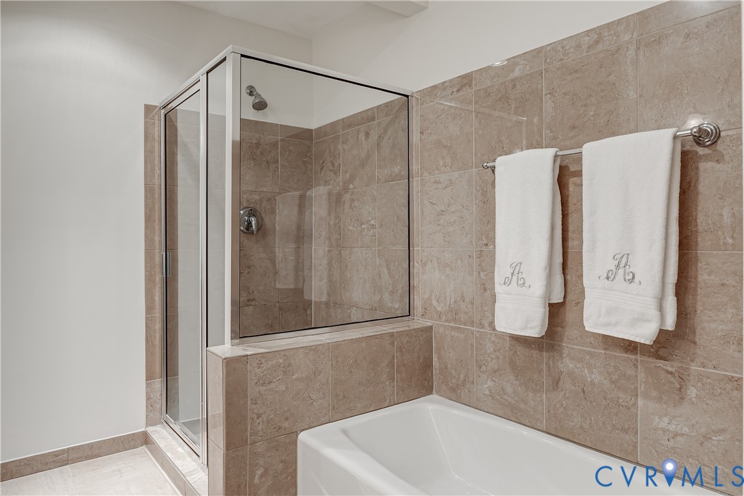 413 Stuart Circle, Unit 3D Richmond, VA 23220 - Photo 21 of 26 a bathroom with a shower and a tub
