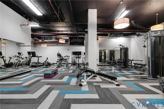 a gym room with lots of gym equipment