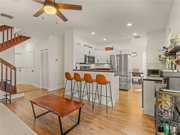 a living room with furniture and kitchen view