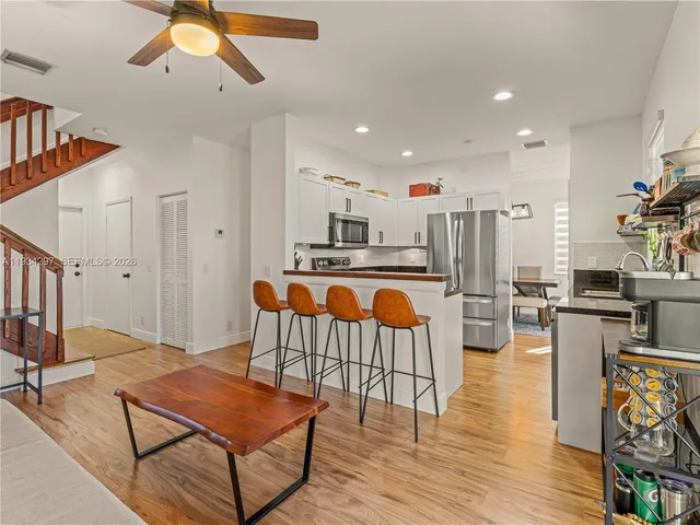 a living room with furniture and kitchen view