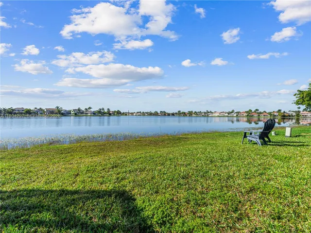 a view of a lake with houses in the back