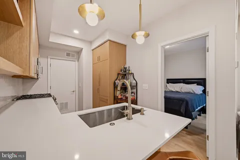 a bedroom with a bed and a chandelier