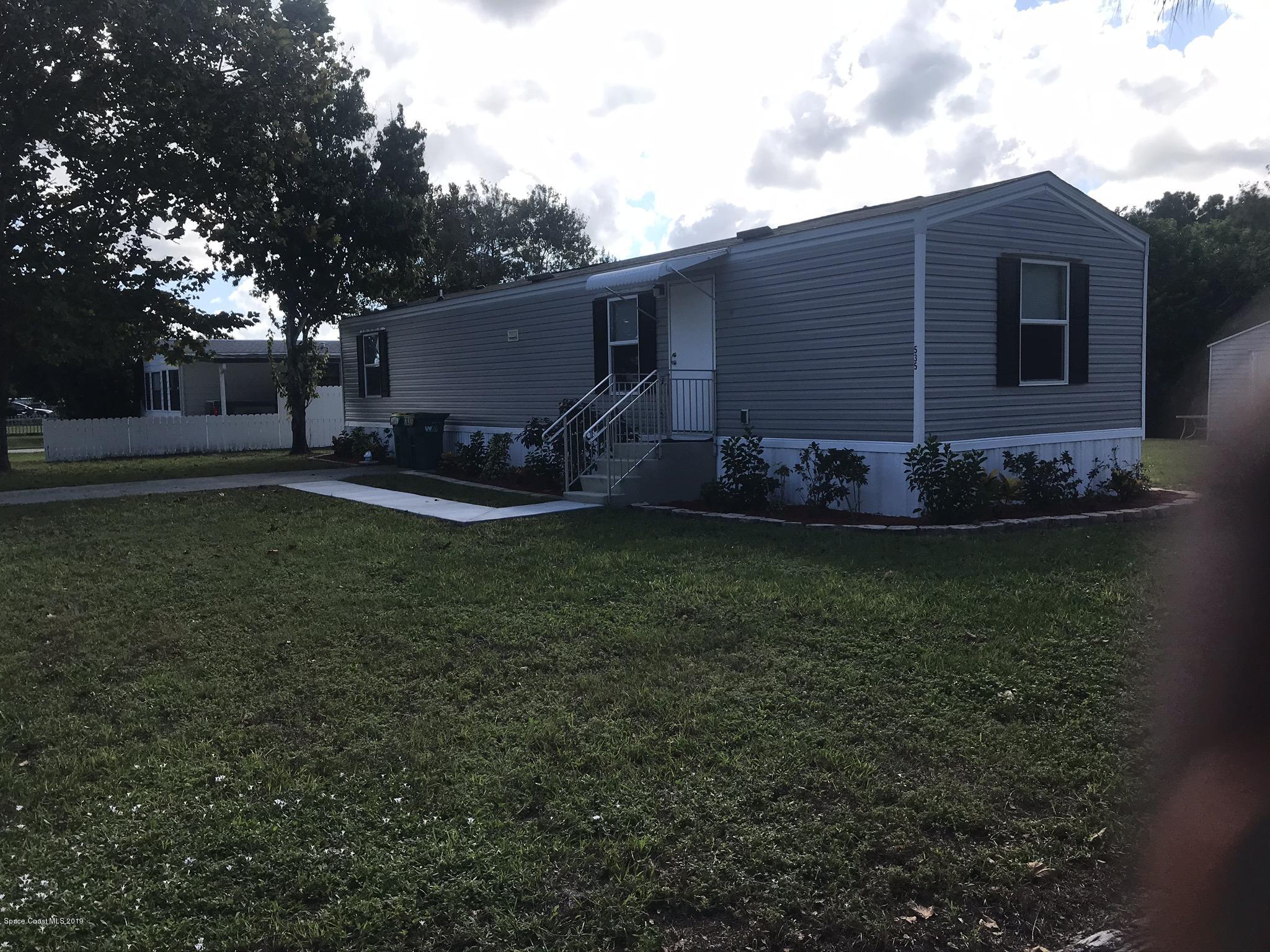 535 Baker Road Merritt Island, FL 32953 - Photo 2 of 34 a view of a house with backyard and sitting area