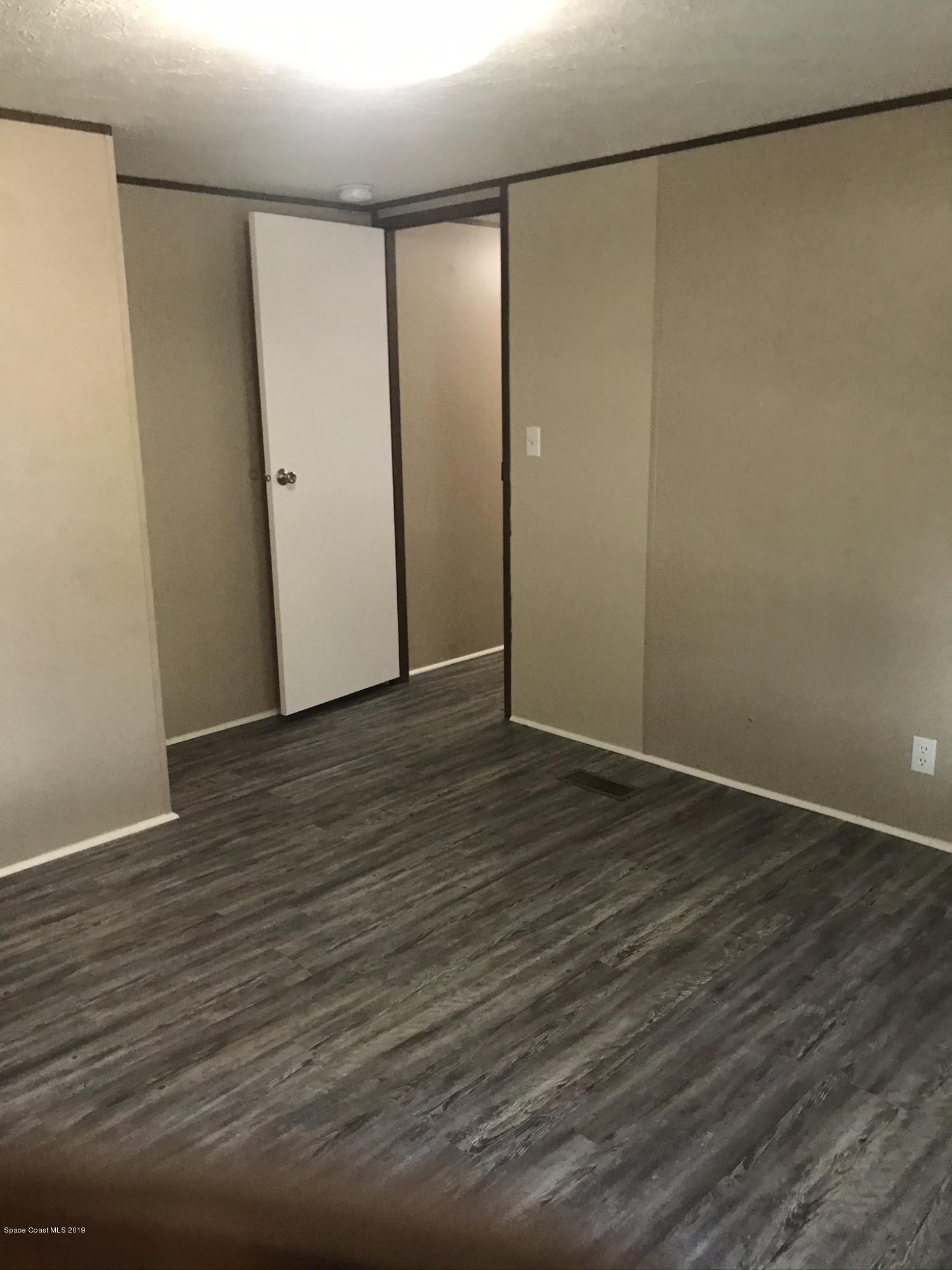535 Baker Road Merritt Island, FL 32953 - Photo 16 of 34 a view of an empty room with wooden floor