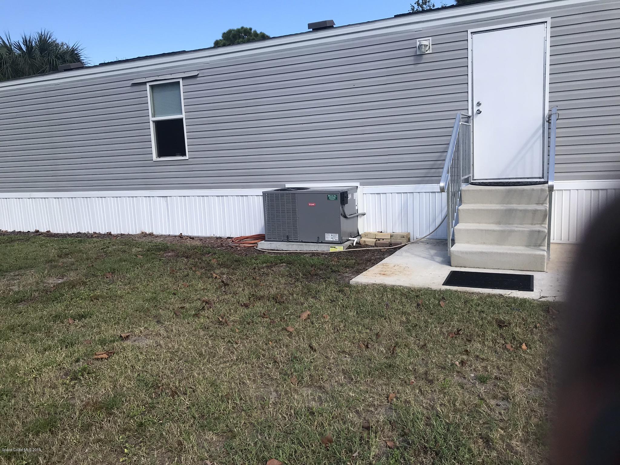 535 Baker Road Merritt Island, FL 32953 - Photo 29 of 34 a view of a house with a yard