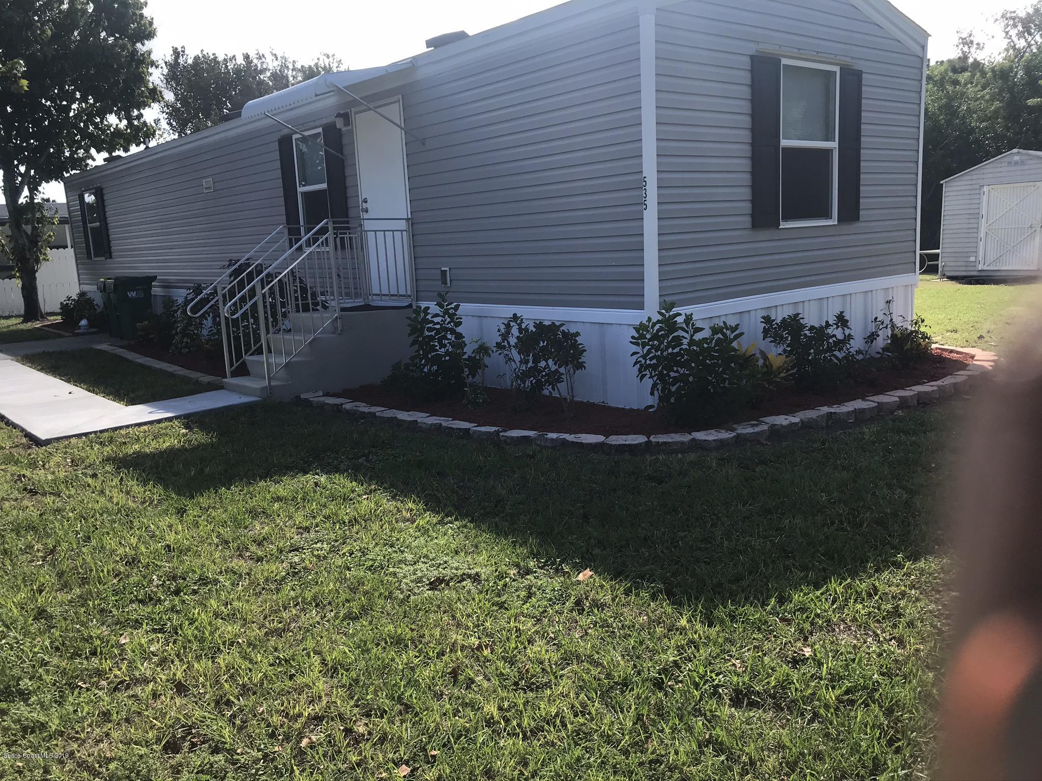 535 Baker Road Merritt Island, FL 32953 - Photo 4 of 34 a view of a house with a yard and garden