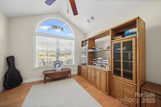 a living room with furniture a flat screen tv and a large window