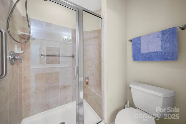 a white toilet sitting next to a bathroom sink
