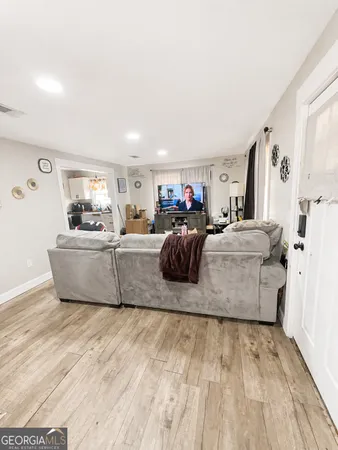 a living room with furniture and a chandelier