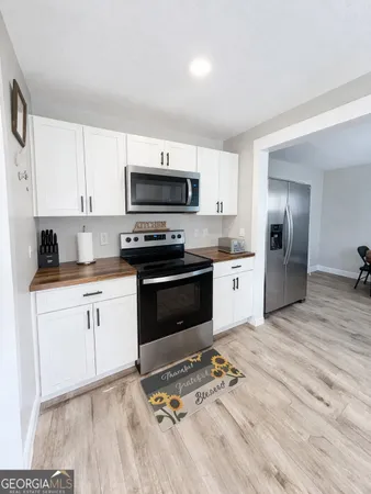 a view of a livingroom with furniture and wooden floor