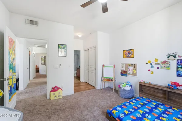 a bedroom with a bed and a window