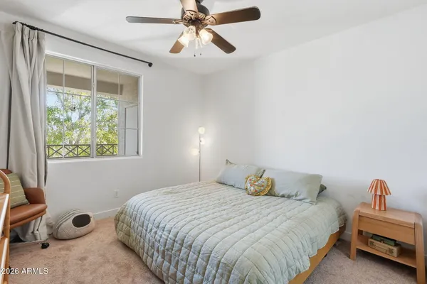 a bedroom with furniture and a book shelf