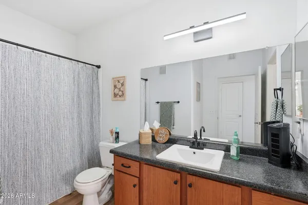 a bathroom with a sink vanity and a mirror