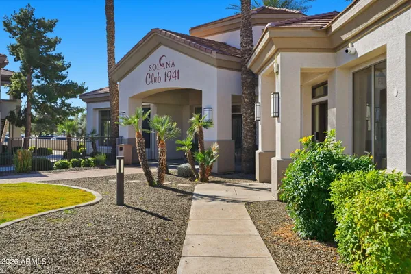 a glass building with swimming pool and outdoor seating