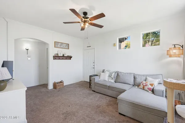 a living room with furniture and a chandelier