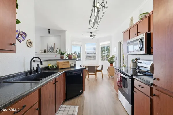 a kitchen with stainless steel appliances granite countertop a sink and cabinets
