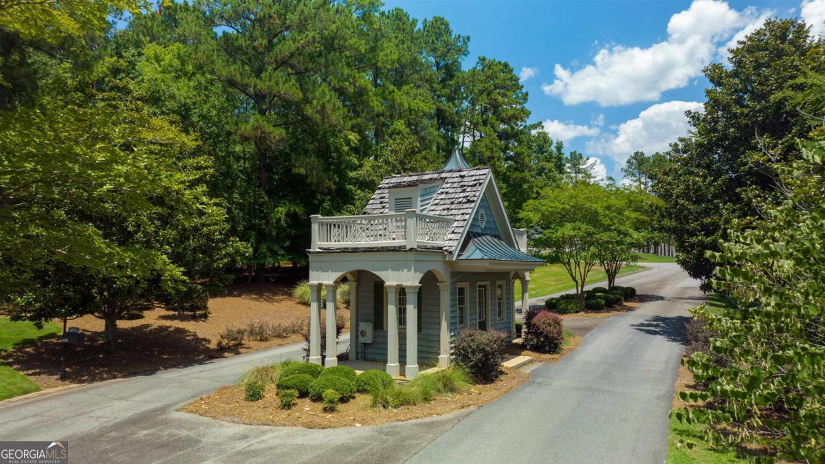 1311 Lighthouse Circle Greensboro, GA 30642 - Photo 25 of 26 a view of a house with brick walls plants and large tree