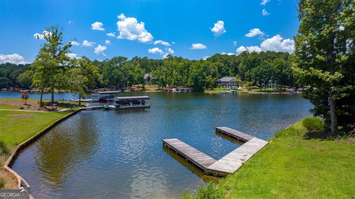 1311 Lighthouse Circle Greensboro, GA 30642 - Photo 3 of 26 a view of a lake with a patio