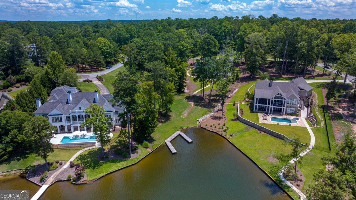 1311 Lighthouse Circle Greensboro, GA 30642 - Photo 5 of 26 an aerial view of a house with a garden and lake view